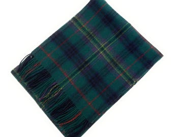 May include: A green, navy, and red plaid scarf with fringed edges. The scarf has a classic tartan pattern, with a mix of dark green, navy blue, red, and yellow lines. The fringed edges add a decorative touch.