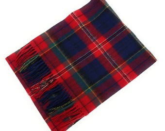 May include: A rectangular scarf with a red, blue, and green tartan pattern. The scarf has a fringed edge in red, blue, and green. The scarf is made of a soft, woven material.
