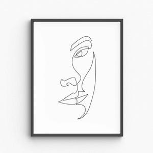 May include: A framed art print with a minimalist line drawing of a face. The artwork shows a side profile of a face, created with a single continuous line, highlighting the eye, nose, and lips against a white backdrop.