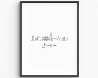 May include: Framed minimalist art print featuring a continuous line drawing of the Bratislava skyline. The artwork is in black against a white background, with the city's name scripted below the skyline.