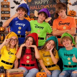 May include: A group of seven people wearing colorful t-shirts and matching hats, each printed with a dwarf name and a belt with buttons. The shirts are blue, green, orange, yellow, red, gold, and teal, featuring names like Sneezy, Dopey, and Happy.
