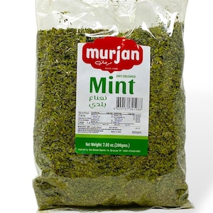 May include: A clear plastic bag filled with dry crushed mint. The bag has a label with the brand name "murjan" in red and white, and the word "Mint" in green. The net weight is 7.05 oz (200 gms).