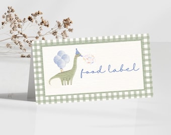 Puede incluir: Una tarjeta de etiqueta de comida con una ilustración de acuarela de un dinosaurio verde con un gorro de fiesta y globos. La tarjeta tiene un borde de cuadros verdes y blancos y las palabras "food label" en escritura azul.