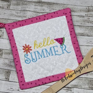 May include: Pink and white pot holder with a white background and a pink border. The pot holder has embroidered text that says "hello summer" with a watermelon slice and a flower.