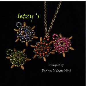 May include: Four beaded turtle pendants in different colors, including green, orange, pink, and blue. The turtles are made with seed beads and have gold-colored accents. The text "Ietzy's" and "Designed by Riana Olckers©2015" is visible in the image.