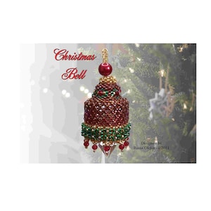 May include: A red and green beaded Christmas bell ornament with gold accents. The ornament is hanging from a Christmas tree. The text "Christmas Bell" is written above the ornament. The text "Designed by Riana Olckers © 2011" is written below the ornament.