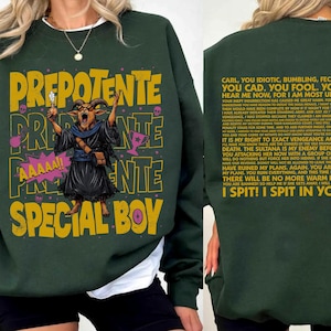 May include: A dark green sweatshirt featuring a graphic of a goat in a robe with the text PREPOTENTE SPECIAL BOY and AAAAA!! on the front. The back displays a long block of text starting with CARL, YOU IDIOTIC, BUMBLING, FECKLESS IMBECILE.