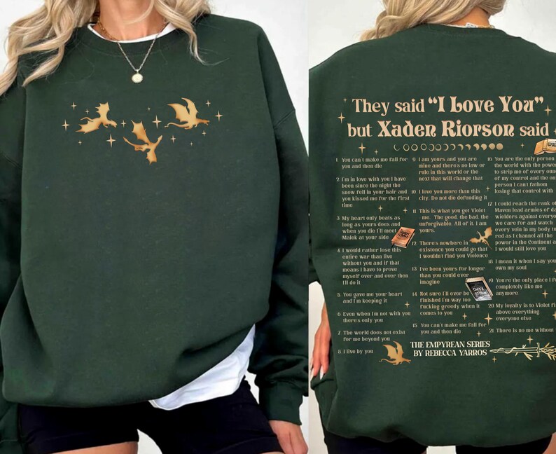 May include: Dark green sweatshirt with gold dragon and star graphics. The front features three dragons and stars. The back has text that reads "They said 'I Love You' but Xaden Riorson said..." with a list of quotes. The Empyrean Series by Rebecca Yarros.