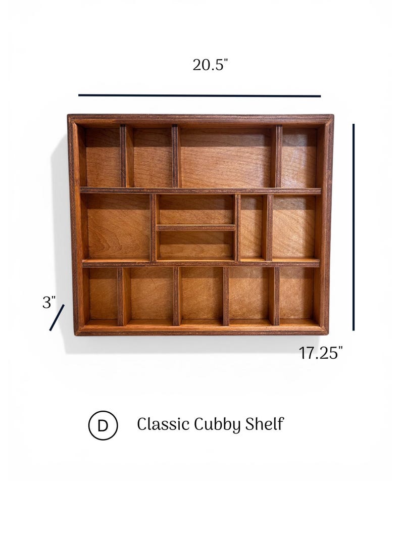 May include: A rectangular wooden cubby shelf with multiple compartments of varying sizes. The shelf measures 20.5 inches in width, 17.25 inches in height, and 3 inches in depth. The text D Classic Cubby Shelf is visible below the shelf.