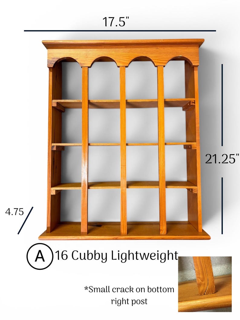 May include: A light brown wooden wall shelf with 16 cubbies, featuring an arched top design. It measures 17.5 inches wide, 21.25 inches high, and 4.75 inches deep. A small crack is visible on the bottom right vertical post of the unit.