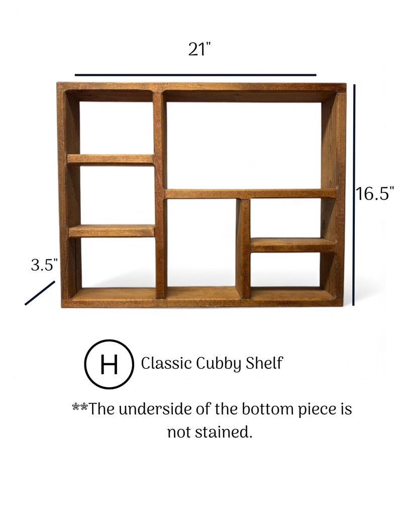 May include: A brown wooden cubby shelf with multiple compartments. The shelf measures 21 inches wide, 16.5 inches high, and 3.5 inches deep. Text on the image reads: H Classic Cubby Shelf, and The underside of the bottom piece is not stained.