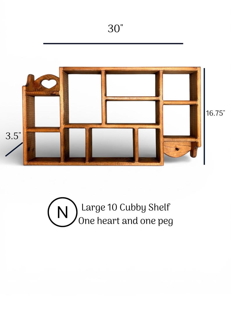 May include: A brown wooden wall shelf with ten cubbies, a heart-shaped cutout on the top left, and a single peg on the bottom right. The shelf measures 30 inches wide, 16.75 inches high, and 3.5 inches deep. Text reads: Large 10 Cubby Shelf, One heart and one peg.