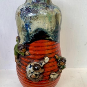 a Japanese Sumida Gawa pottery vase. drip glaze and high relief children