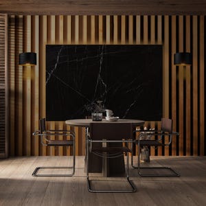 May include: A dining room with a round wooden table and four brown leather chairs with chrome frames. The room features a black marble wall, wooden paneling, and two black sconces. The floor is made of wooden planks.