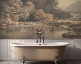 May include: A freestanding, beige clawfoot bathtub with ornate silver feet. The tub is set against a wall with a sepia-toned mural depicting a river scene with trees, people, and animals. The faucet is silver.