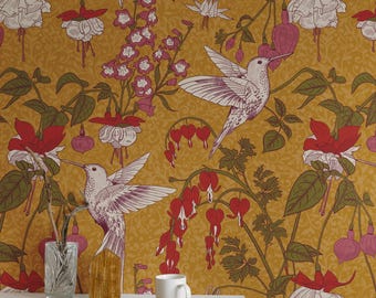 May include: Mustard-colored wallpaper featuring a repeating pattern of hummingbirds, fuchsia flowers, and bleeding hearts. The birds are white with purple accents. The flowers are red, white, and pink. The wallpaper creates a vibrant, nature-inspired aesthetic.