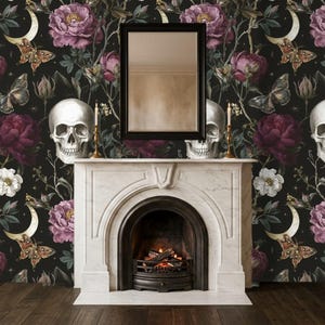 May include: A white marble fireplace mantel with a black arched firebox containing a fire, topped by a rectangular mirror. The wall features dark wallpaper with a repeating pattern of white skulls, purple peonies, white flowers, and moths.