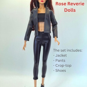 May include: A fashion doll wearing a black jacket, crop top, and pants. The doll has long auburn hair and is wearing black shoes. The text "Rose Reverie Dolls" is visible. The set includes a jacket, pants, crop-top, and shoes.