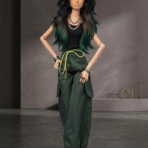May include: A fashion doll with long dark hair featuring green highlights, wearing a black sleeveless top, dark green cargo pants with a bright yellow drawstring, silver chain necklaces, hoop earrings, and stacked bracelets on both wrists.