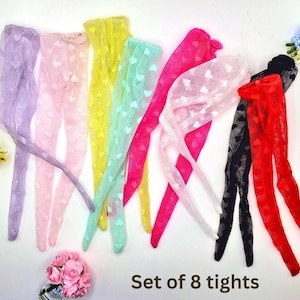 May include: A set of eight colorful tights, each with a heart pattern. The tights come in various colors, including purple, pink, yellow, green, and red. The text "Set of 8 tights" is visible.