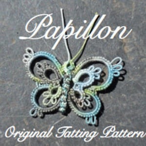 May include: A delicate, hand-crafted butterfly tatting pattern, featuring a blue, green, and gray color scheme. The pattern is labeled "Papillon Original Tatting Pattern".