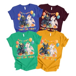 May include: Four short-sleeved t-shirts in blue, burgundy, green, and yellow. Each shirt features a cartoon dragon design with balloons, party hats, and gift boxes. The text "CUSTOM TEXT" is printed below the design.