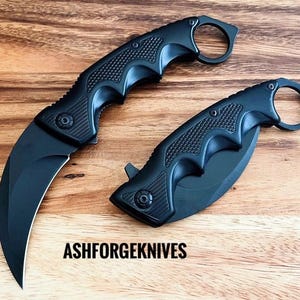 Zwart karambitmes karambit: veerondersteund tactisch zakmes