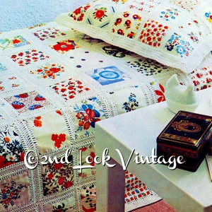 May include: A vintage-style quilt and pillow set with a patchwork design. The quilt features squares of fabric with floral patterns in red, blue, and yellow, joined by white crochet. A white ceramic chicken and a black box with gold accents sit on a white table.
