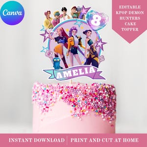 May include: A Kpop Demon Hunters themed cake topper featuring three animated characters, a blue creature, and a heart-shaped balloon with the number 8. The topper includes a banner with the name AMELIA and is displayed on a pink cake with sprinkles.