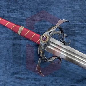 May include: A sword featuring a long, double-edged steel blade and a complex, dark metal hilt with ornate scrollwork. The grip is wrapped in red material with gold-colored wire accents, topped by a circular pommel with a floral design.