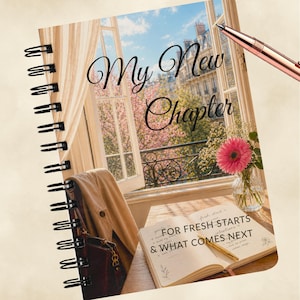 May include: Spiral-bound journal with the words "My New Chapter" on the cover, featuring a scenic Parisian window view. The journal is open to a page with the text "FOR FRESH STARTS & WHAT COMES NEXT". A pen rests on the page, and a vase of flowers sits nearby.