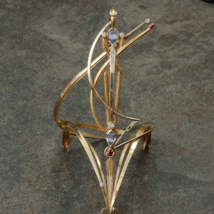 14 karat white and yellow gold wearable &quot;Celebration&quot; sculpture with sapphires, rubies and diamonds.
