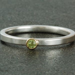August birthstone ring, natural peridot. Sterling silver ring available with white or yellow gold bezel; stacking