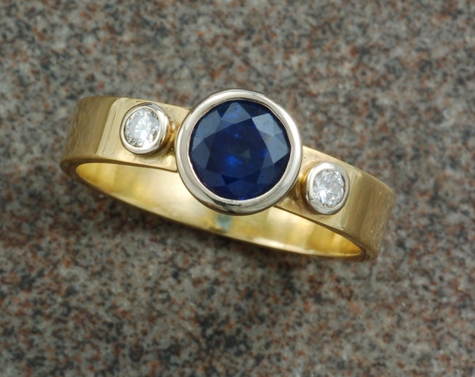 Blue sapphire and diamond ring set in 14 karat white and 18 karat yellow gold.