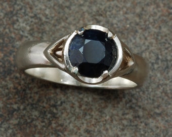Sterling silver ring set with round natural black sapphire.