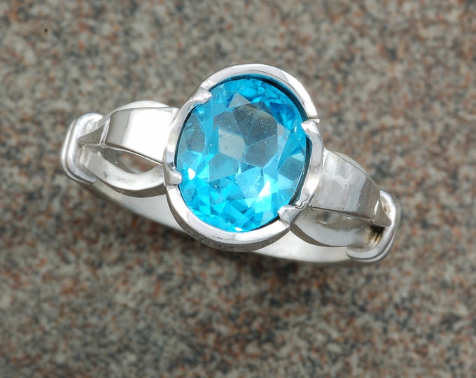 White gold shepherds hook ring set with a Swiss blue topaz.