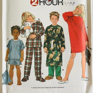 May include: Simplicity sewing pattern 7407 featuring children's sleepwear. The pattern includes options for a nightgown, pajamas, and a robe. The image shows illustrations of children in various sleepwear styles. The pattern size is AA 3,4,5,6.