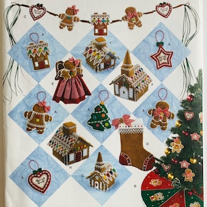 May include: Simplicity pattern 2545 featuring Christmas ornaments. The pattern includes gingerbread men, houses, a star, a tree, a stocking, and a heart. The ornaments are decorated with white icing and red accents. The pattern is one size.