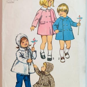 May include: Vintage Simplicity pattern 5934 for toddler coats. The cover features illustrations of children in pink, blue, and patterned coats. The pattern includes size 1, breast 20 inches, and waist 19 1/2 inches.