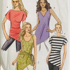 May include: A sewing pattern featuring four different tunic tops. The tops are in various colors and styles, including a red short-sleeved top, a purple V-neck top, a green leaf-patterned top with a wrap, and a black and white striped top.