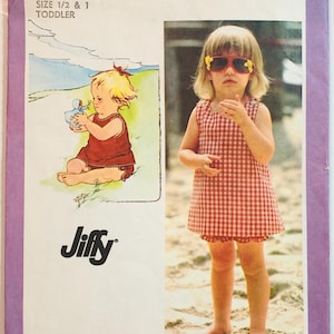May include: Vintage Simplicity pattern 9386 for toddler clothing. The cover features a little girl in a red and white checkered dress and sunglasses. The pattern includes two sizes: 1/2 and 1.