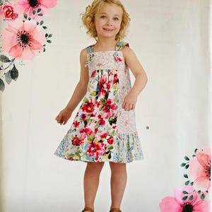 May include: A Simplicity sewing pattern envelope D0916 for a sleeveless dress in U.S. sizes 3-8. The front features a floral print dress with a square neckline and shoulder straps, decorated with pink watercolor flowers and green leaves.