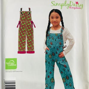 May include: A Simplicity sewing pattern envelope A1742 for overalls in sizes 3-8. The package features the text IT'S SO EASY and Simply Daisy Kingdom. It displays illustrations of green overalls with red flowers and a teal version with owl motifs.