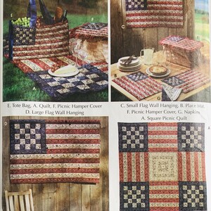 May include: A collection of quilted picnic accessories, including a tote bag, quilt, picnic hamper cover, wall hangings, place mats, and napkins. The designs feature a patriotic theme with red, white, and blue colors, resembling the American flag. The image also includes text labels.