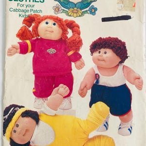 May include: Vintage Cabbage Patch Kids clothing pattern. The pattern features illustrations of three Cabbage Patch Kids dolls wearing different outfits. The pattern is from Butterick and includes the text "Clothes for your Cabbage Patch Kids".