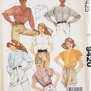May include: McCall's sewing pattern featuring illustrations of women's tops. The designs include button-down shirts, striped blouses, and short-sleeved tops in various colors. The pattern includes the text "Shari Belafonte Harper".