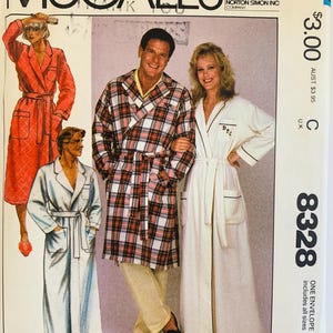 May include: Vintage McCall's sewing pattern envelope featuring illustrations of bathrobes. The envelope shows a man in a plaid robe and a woman in a white robe. The pattern number is 8328.