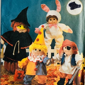 May include: Image of a pattern for soft-sculpted dolls in Halloween costumes. The dolls are dressed as a witch, a bunny, a clown, and a pirate. The clown doll holds a "Trick or Treat" bag. The pattern is for 18-inch dolls.