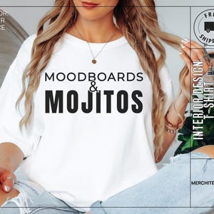 May include: White t-shirt with black text that reads "Moodboards & Mojitos" and "Interior Design T-Shirt". The shirt is being worn by a person with long blonde hair.
