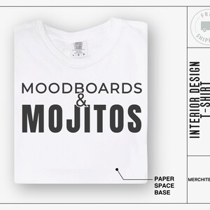 May include: White t-shirt with black text that reads "MOODBOARDS & MOJITOS". The text is centred on the shirt. The shirt is folded in half and lying on a white surface.